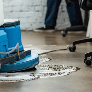 cropped view of cleaner washing floor with cleaning machine, panoramic shot