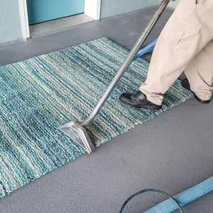 Man has small business cleaning carpets by shampooing and then steam cleaning.